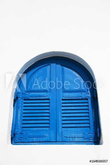 Picture of Window with blue shutters against a white wall on the island of Santorini Greece Europe